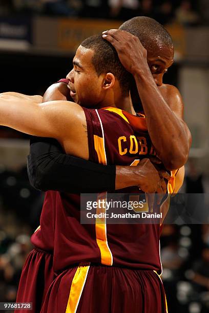 Forward Paul Carter and guard Justin Cobbs of the Minnesota Golden Gophers celebrate after defeating the Purdue Boilermakers 69-42 in the semifinals...