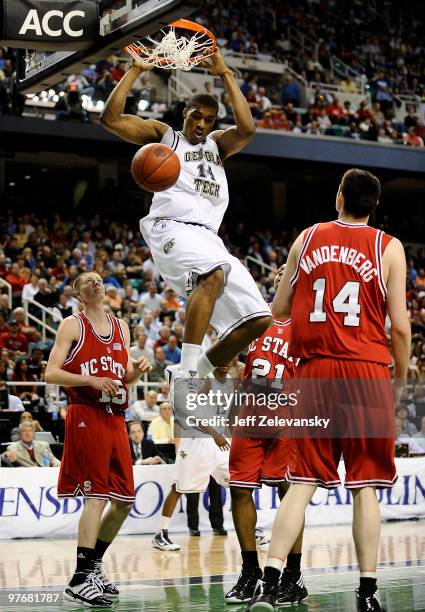 Derrick Favors of the Georgia Tech Yellow Jackets dunks against Scott Wood, C.J. Williams and Jordan Vandenburg of the North Carolina State Wolfpack...