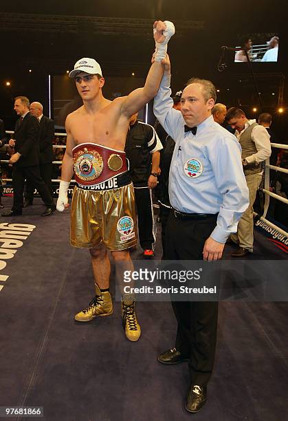 Marco Huck of Germany celebrates as the ring referee Marc Nelson lifts his arm after the WBO World Championship Cruiserweight title fight against...