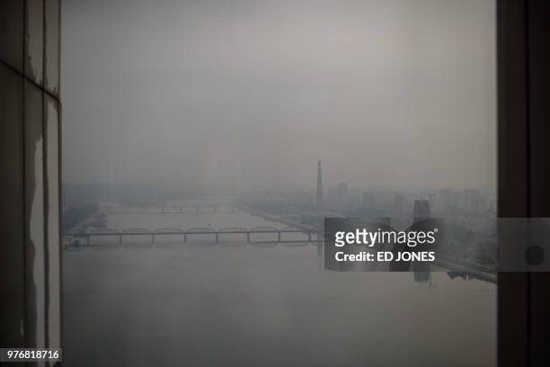An elevated view shows the Juche tower in the distance across the Taedong river on a misty day in Pyongyang on June 17, 2018. - Donald Trump dangled...