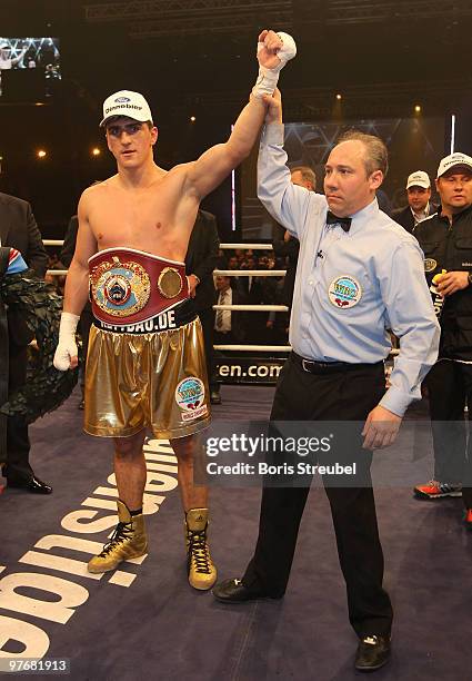 Marco Huck of Germany celebrates as the ring referee Marc Nelson lifts his arm after the WBO World Championship Cruiserweight title fight against...