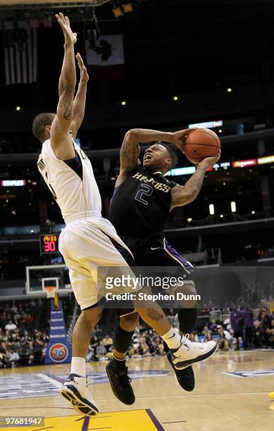 Isaiah Thomas of the Washington Huskies shoots over Jerome Randle of the California Golden Bears during the championship game of the Pac-10...