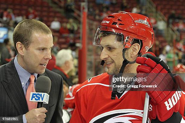 Color Analyst Tripp Tracy interviews Brian Pothier of the Carolina Hurricanes after his game winning goal against the Pittsburgh Penguins prior to a...