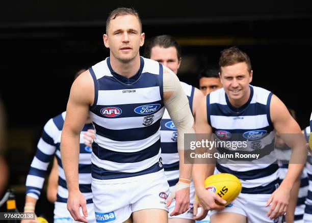 Joel Selwood of the Cats leads his team out onto the field during the round 13 AFL match between the Geelong Cats and the Richmond Tigers at...