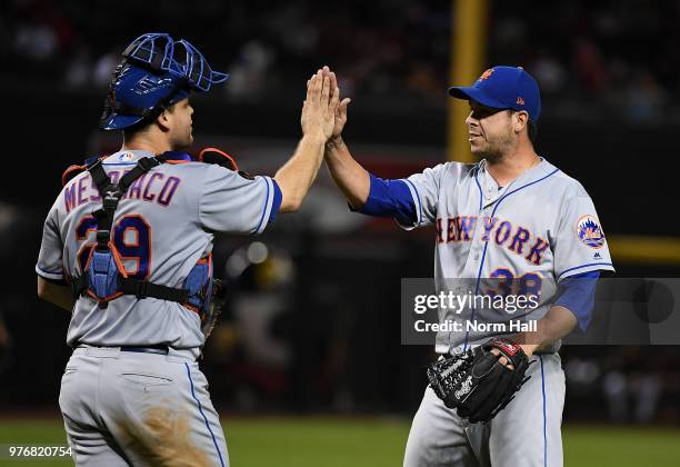 Anthony Swarzak and Devin Mesoraco of the New York Mets celebrate a 5-1 win against the Arizona Diamondbacks at Chase Field on June 16, 2018 in...