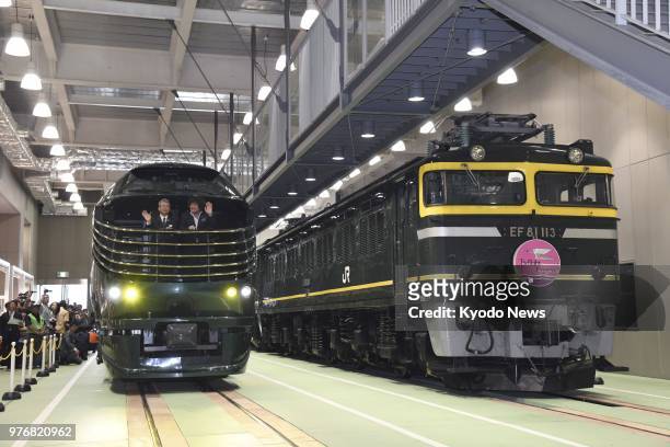 West Japan Railway Co.'s Twilight Express Mizukaze luxury sleeper train, in commemoration of its first year of operations, is displayed beside an old...