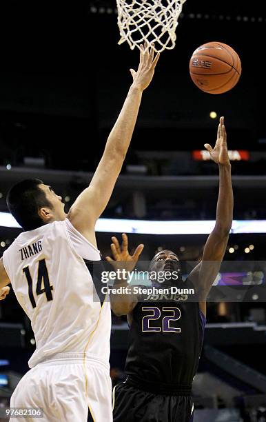 Justin Holiday of the Washington Huskies shoots against Max Zhang of the California Golden Bears during the championship game of the Pac-10...