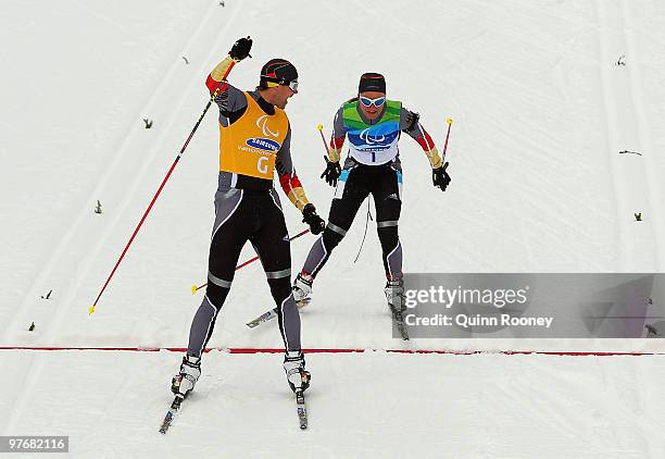 Verena Bentele and her guide Thomas Friedrich of Germany celebrate winning the Women's 3km Pursuit Visually Impaired Biathlon on Day 2 of the 2010...