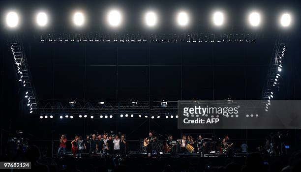 Argentinian musicians perform during the "Argentina embraces Chile" solidarity concert in Palermo park, Buenos Aires, on March 13, 2010. The concert...