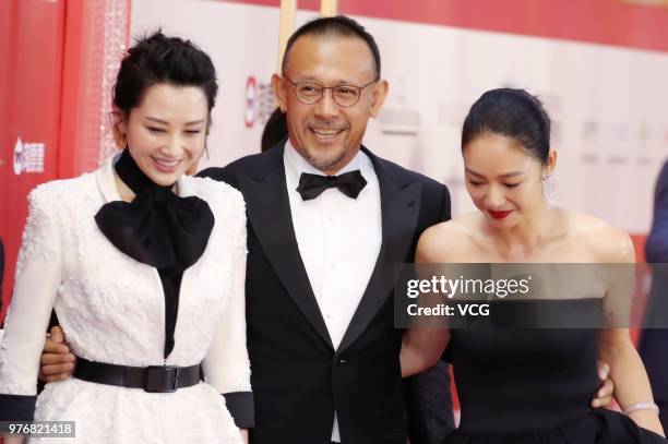 Actress Summer Xu Qing, director Jiang Wen and his wife actress Zhou Yun arrive at red carpet during the opening ceremony of the 21st Shanghai...