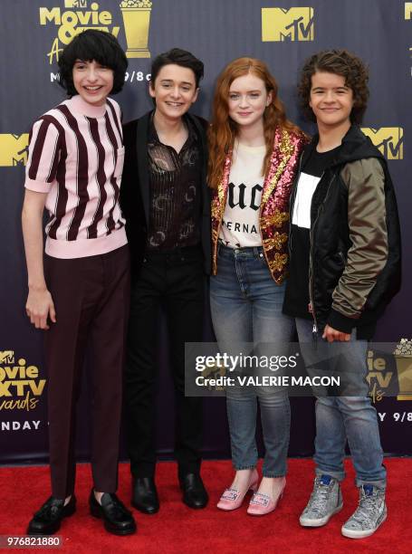 Actors Finn Wolfhard , Noah Schnapp , Sadie Sink, and Gaten Matarazzo attend the 2018 MTV Movie & TV awards, at the Barker Hangar in Santa Monica on...