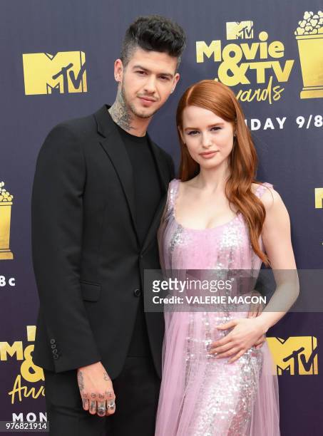 Actors Travis Mills and Madelaine Petsch attend the 2018 MTV Movie & TV awards, at the Barker Hangar in Santa Monica on June 16, 2018. - This year's...