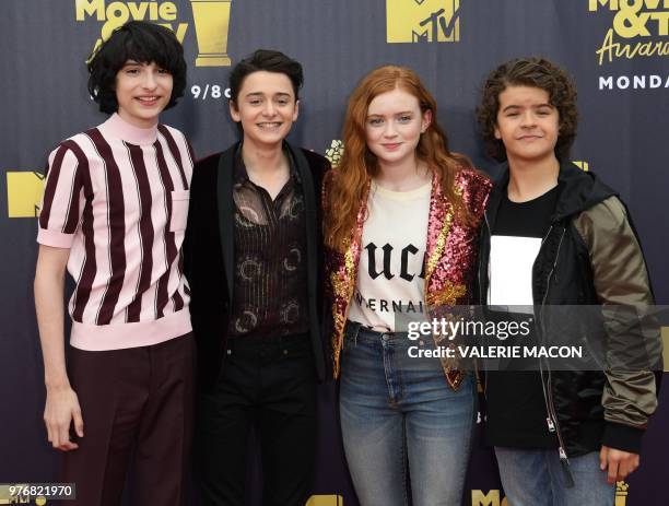 Actors Finn Wolfhard , Noah Schnapp , Sadie Sink, and Gaten Matarazzo attend the 2018 MTV Movie & TV awards, at the Barker Hangar in Santa Monica on...