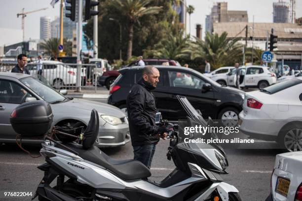 Dpatop - A man stands next to his motorcycle on a highway and observes two minutes of silence to mark the Yom HaShoah , which commemorates...