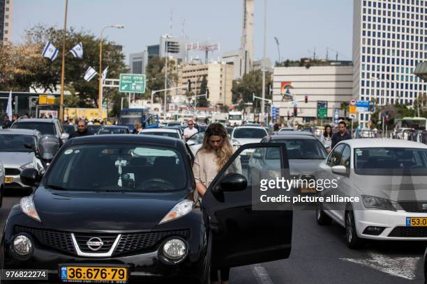 People exit their cars on a highway and observe two minutes of silence to mark the Yom HaShoah , which commemorates approximately six million Jews...