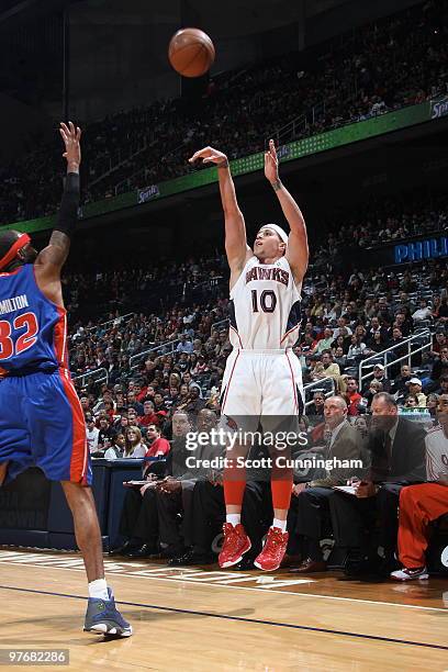 Mike Bibby of the Atlanta Hawks puts up a three-point shot against Richard Hamilton of the Detroit Pistons on March 13, 2010 at Philips Arena in...