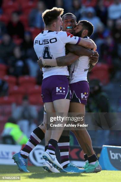 Josh Addo-Carr of the Storm celebrates his try with team mates during the round 15 NRL match between the Newcastle Knights and the Melbourne Storm at...