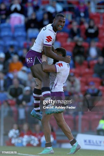 Josh Addo-Carr of the Storm celebrates his try with team mates during the round 15 NRL match between the Newcastle Knights and the Melbourne Storm at...