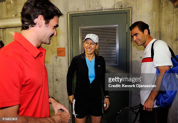 Tennis legends Pete Sampras of the United looks on as Martina Navratilova of the United States speaks with Roger Federer of Switzerland after...