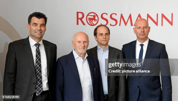 April 2018, Germany, Burgwedel: Managing director Peter Dreher , Dirk and Raoul Rossmann and managing director Michael Rybak pose for photographs...