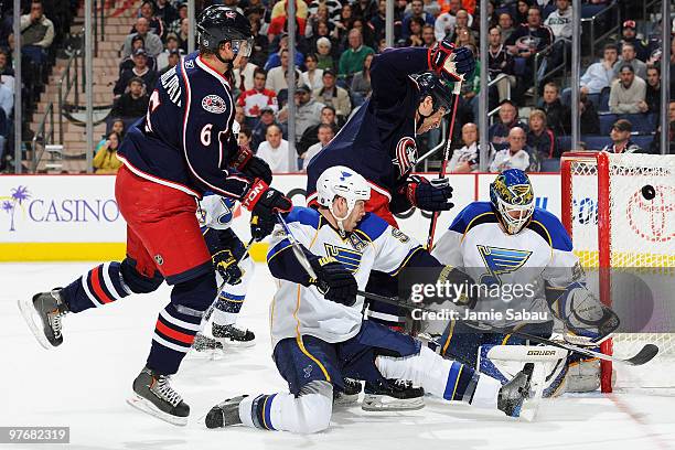 Anton Stralman and R.J. Umberger, both of the Columbus Blue Jackets, battle for positioning in front of Barret Jackman and goaltender Chris Mason,...