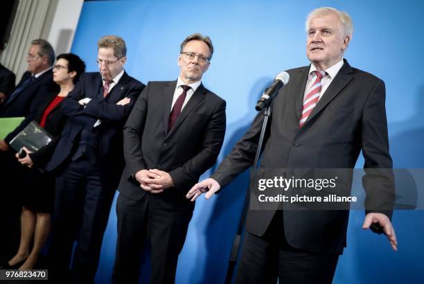 April 2018, Germany, Berlin: German Interior Minister Horst Seehofer speaking to the media beside Holger Muench , president of the Bundeskriminalamt...