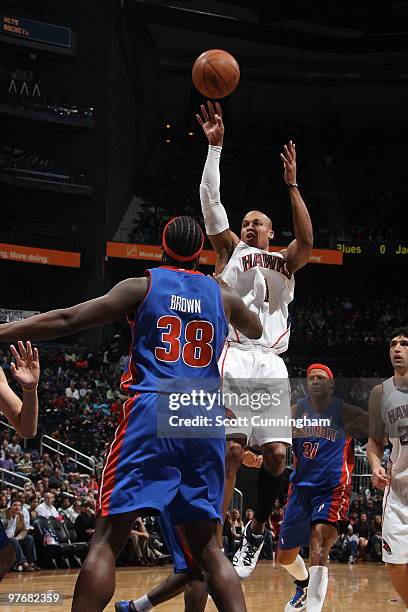 Maurice Evans of the Atlanta Hawks shoots against Kwame Brown of the Detroit Pistons on March 13, 2010 at Philips Arena in Atlanta, Georgia. NOTE TO...