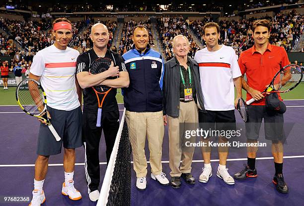 Rafael Nadal of Spain, his doubles teammate Andre Agassi, chair umpire Mohamed Lahyani, tennis legend Rod Laver, former player Pete Sampras, and...
