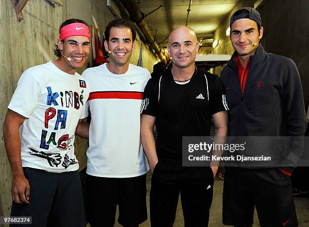 Rafael Nadal of Spain, his doubles teammate Andre Agassi, former player Pete Sampras, and his doubles teammate Roger Federer of Switzerland, during...