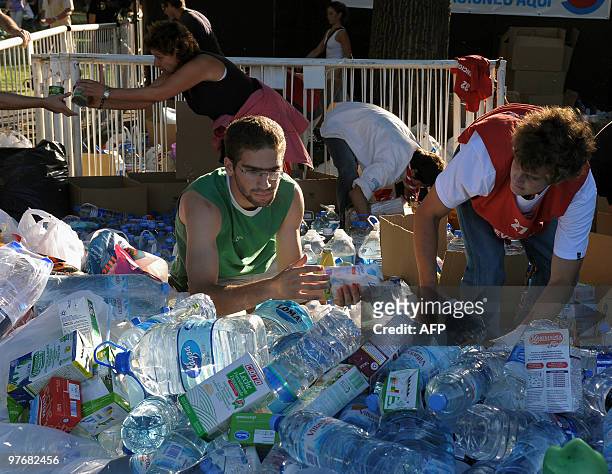 Volunteers load the donations of non-perishable food and clothes into trucks during the "Argentina embraces Chile" solidarity concert in Palermo...