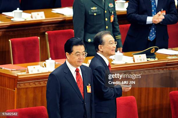 Chinese Premier Wen Jiabao walks pass Chinese President Hu Jintao as they arrive for the closing session of the National People's Congress at the...