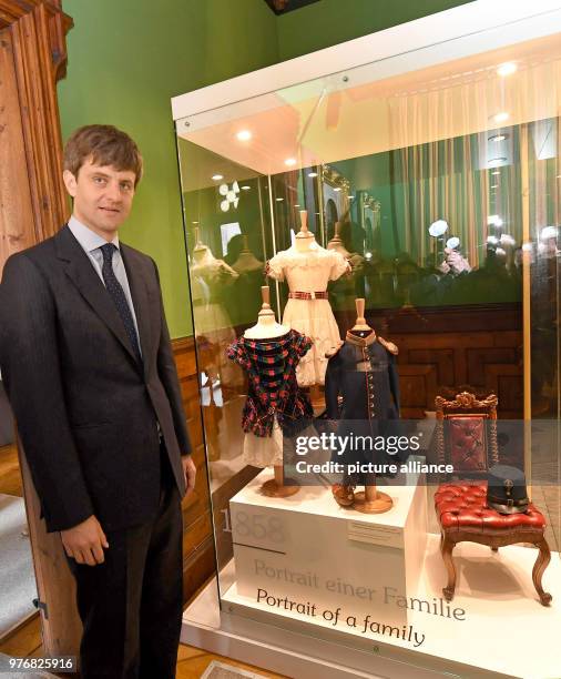 April 2018, Pattensen, Germany: Ernst August Jr. Of Hanover stands next historical children's clothing at the exhibition "200 Years of Marie and...