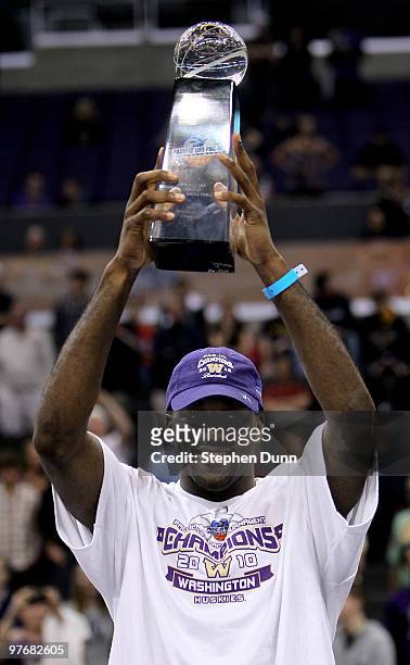 Quincy Pondexter of the Washington Huskies holds up the trophy after the game against the California Golden Bears during the championship game of the...
