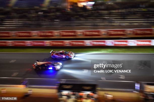 Ferrari 488 GTE German driver Lucas Stolz competes during the 86th Le Mans 24-hours endurance race, at the Circuit de la Sarthe at night on June 17,...