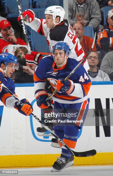 David Clarkson of the New Jersey Devils goes flying as he is hit by Freddy Meyer of the New York Islanders in the second period of an NHL game at the...