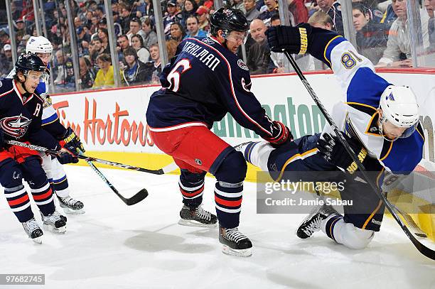 Anton Stralman of the Columbus Blue Jackets checks Jay McClement of the St. Louis Blues while battling for control of the puck during the second...