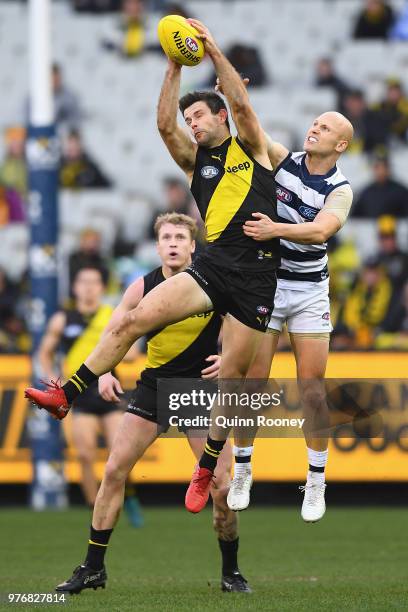 Trent Cotchin of the Tigers marks infront of Gary Ablett of the Cats during the round 13 AFL match between the Geelong Cats and the Richmond Tigers...