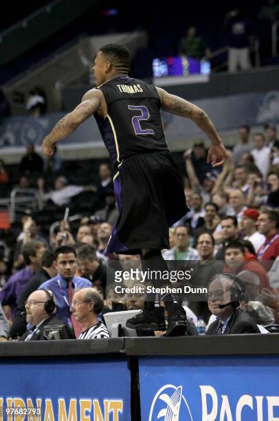 Isaiah Thomas of the Washington Huskies celebrates by jumping onto the scorers' table after the game with the California Golden Bears during the...