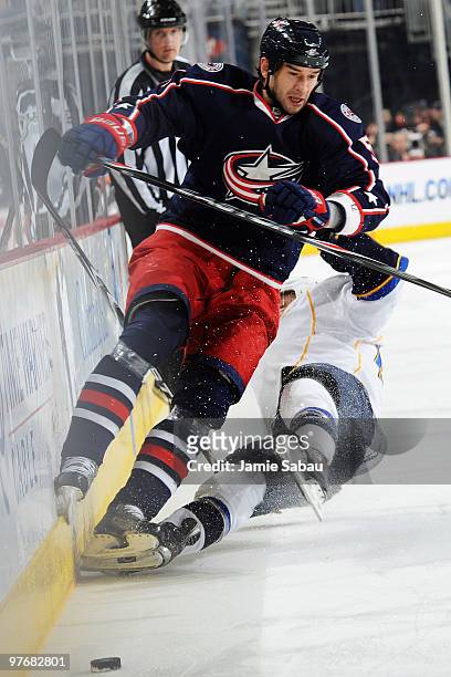 Fedor Tyutin of the Columbus Blue Jackets collides with Andy McDonald of the St. Louis Blues during the second period on March 13, 2010 at Nationwide...
