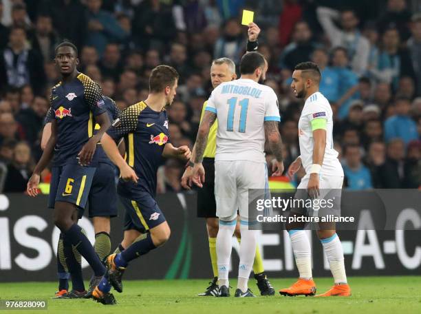 Olympique Marseille's Konstantinos Mitroglou is shown a yellow card by referee Bjoern Kuipers during the UEFA Europa League soccer match between...