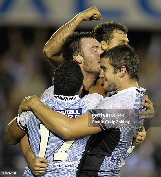 The Sharks celebrate after a try by Luke Douglas during the round one NRL match between the Cronulla Sharks and the Melbourne Storm at Toyota Stadium...