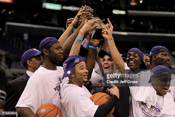 The Washington Huskies celebrate with the trophy following their victory over the Cal Golden Bears in the championship game of the Pac-10 Basketball...