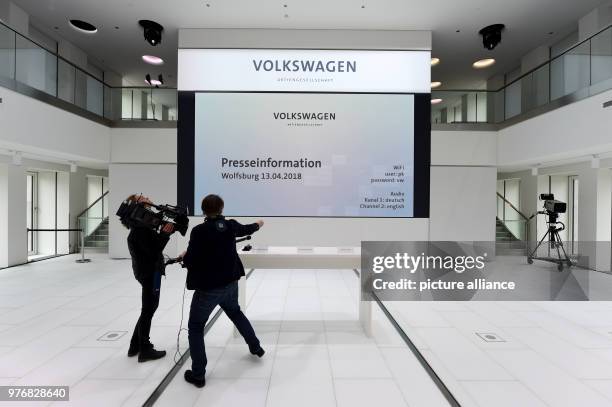 April 2018, Germany, Wolfsburg: A television team filming the table with the name plates just before the start of a press conference after...