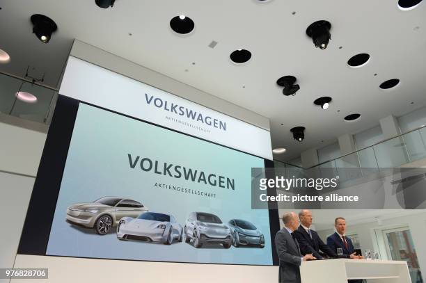 April 2018, Germany, Wolfsburg: New CEO of Volkswagen Herbert Diess , chairman of the governing body Hans Dieter Poetsch and leader of communications...