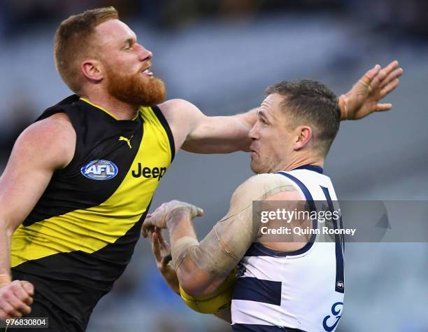 Nick Vlastuin of the Tigers collects Joel Selwood of the Cats as he takes a mark during the round 13 AFL match between the Geelong Cats and the...