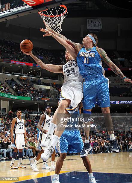 Chris Andersen of the Denver Nuggets attempts to block a shot attempted by Marc Gasol of the Memphis Grizzlies on March 13, 2010 at FedExForum in...