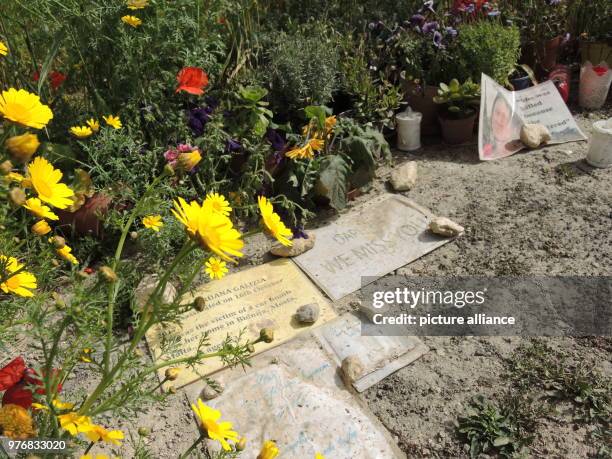 April 2018, Malta, Bidnija: People have left candles and messages at the scene where the car of the murdered journalist Daphne Caruana Galizia burnt...