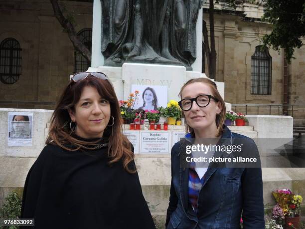 April 2018, Malta, Bidnija: The activists Pia Zammit and Clemence Dujardin standing in front of the improvised cenotaph of the murdered journalist...