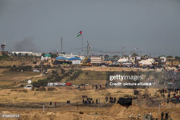 Dpatop - A picture taken from the Israeli side shows Palestinian protesters marching towards the barriers along the borders between Israel and Gaza...