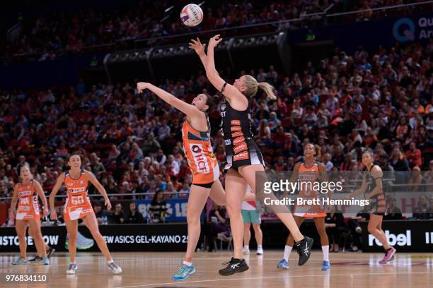 Caitlin Thwaites of the Magpies and Samantha Poolman of the Giants contest the ball during the round seven Super Netball match between the Giants and...